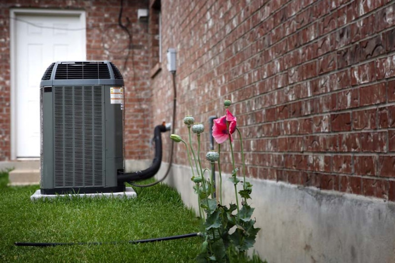 Blog Title: How Does an Air Conditioner Work? Photo: AC unit outside of house