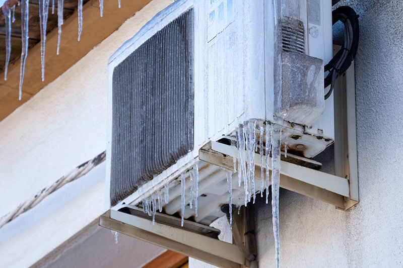 Why Is My Heat Pump Freezing Up? A heat pump that has ice around the outside of the unit.