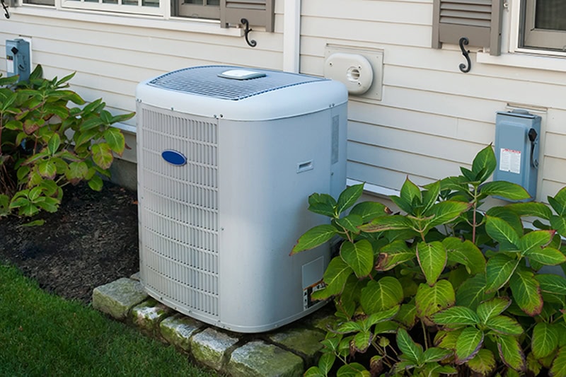 What’s That Smell Coming From My AC at Startup? Photo of an HVAC unit installed outside of a home.